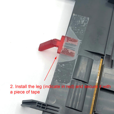 Step 2. Flip over the tray and install the leg.  Use a piece of tape to secure it.